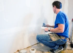 worker doing drywall repair