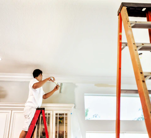 worker painting home interior